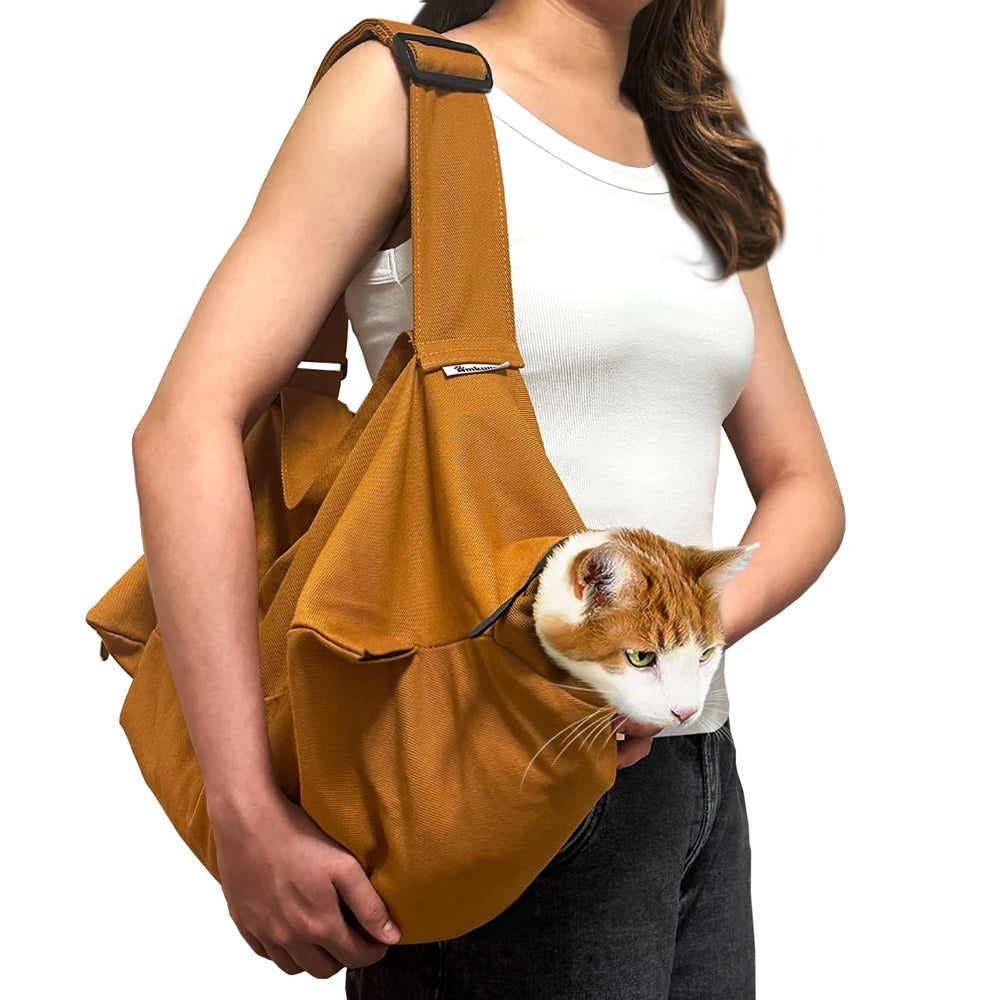 Amkune Cat Carrier Pouch worn on shoulder for hands-free transport and close pet bonding.