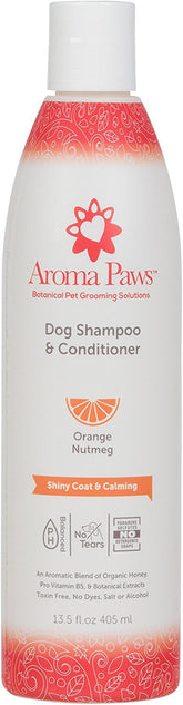 Aroma Paws orange-nutmeg tearless shampoo being poured for a bath.