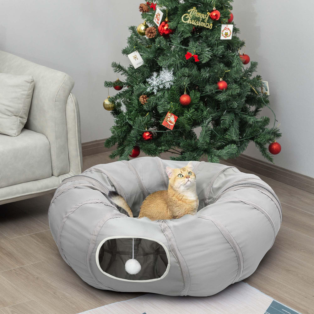 AUOON Cat Play Tunnel under Christmas tree for cozy playtime.