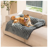 Avont dog bed mat on couch with soft fleece for calming, cozy rest.