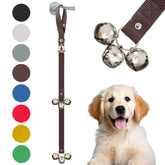 Caldwell's Dog Potty Bells hanging on door provide simple potty signaling for quick bathroom breaks.