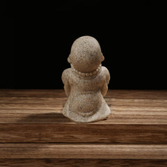 Carefree Fish Buddha statue handcrafted-sandstone texture enhances meditation corner with earthy vibe.
