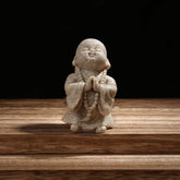 Carefree Fish Buddha statue minimalist-sandstone for tranquil shelf decor and calm ambiance.