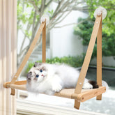 CATISM cat window perch with suction cups provides secure window lounging for curious cats.