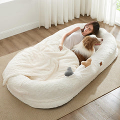 ChiXnuggle human dog bed ivory outer fabric close-up highlights plush lounging comfort.