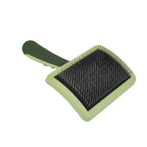 Coastal Dog Slicker Brush green angled view highlights compact design for efficient grooming.