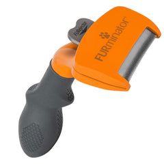FURminator medium dog undercoat deshedding tool with ergonomic handle for comfortable grooming.
