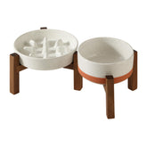 Havniva ceramic raised slow-feeder bowl on acacia stand supports comfortable posture during meals.