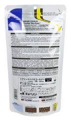 Hikari Cichlid Bio-Gold pellets floating in water illustrate easy portion control.