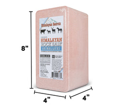 Himalayan Secrets pink salt brick outdoors in pasture with grazing animals