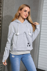 Kei Tomlison pouch hoodie close-up shows cozy fur-lined pouch for snuggling.