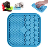 Kwispel lick mat on tub with strong suction for calm bath-time distraction.