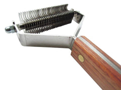 Mars Coat King dematting rake in use on a dog coat for fast grooming