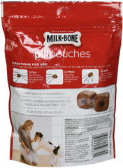 Milk-Bone pill pouches being used during mealtime for easy pill hiding.