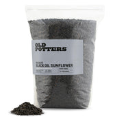 Old Potters Wildlife Black Oil Sunflower Seeds in a backyard feeder for diverse birds and year-round delight.