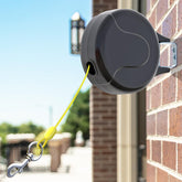 PAWSTATION retractable tie-out wall-mount front view shows safe, tangle-free outdoor activity.