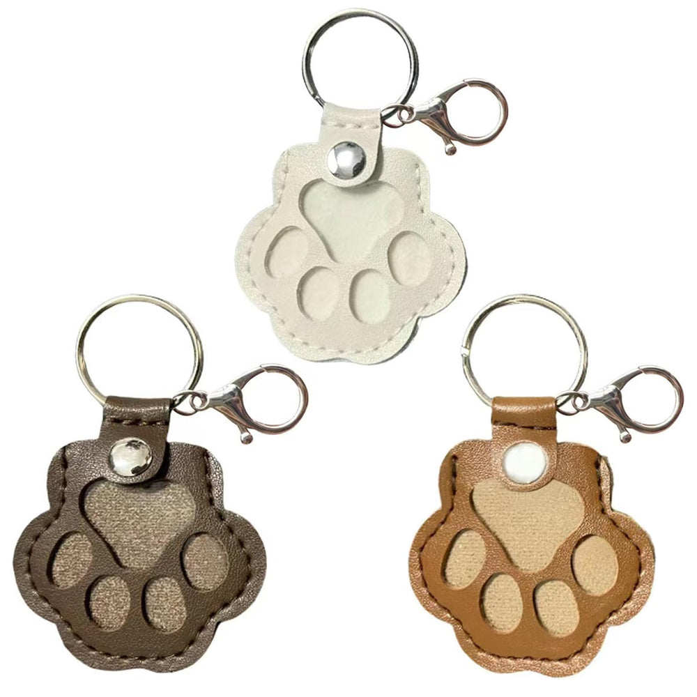 Pet hair fillable keychain cat paw leather closeup highlights memory-keeping on keys.