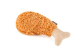 P.L.A.Y. plush fried chicken drumstick (X-Small) encourages playful chewing for small dogs.