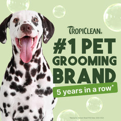 TropiClean deodorizing dog shampoo with aloe coconut scent shown beside a clean coat.