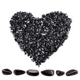 Twdrer black obsidian chips closeup showing irregular shapes for decor and crafts.
