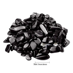 Twdrer black obsidian chips in plant pot arrangement for natural texture and moisture management.