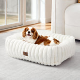 Warmrest washable dog bed side view in cream with raised edges for cozy neck support