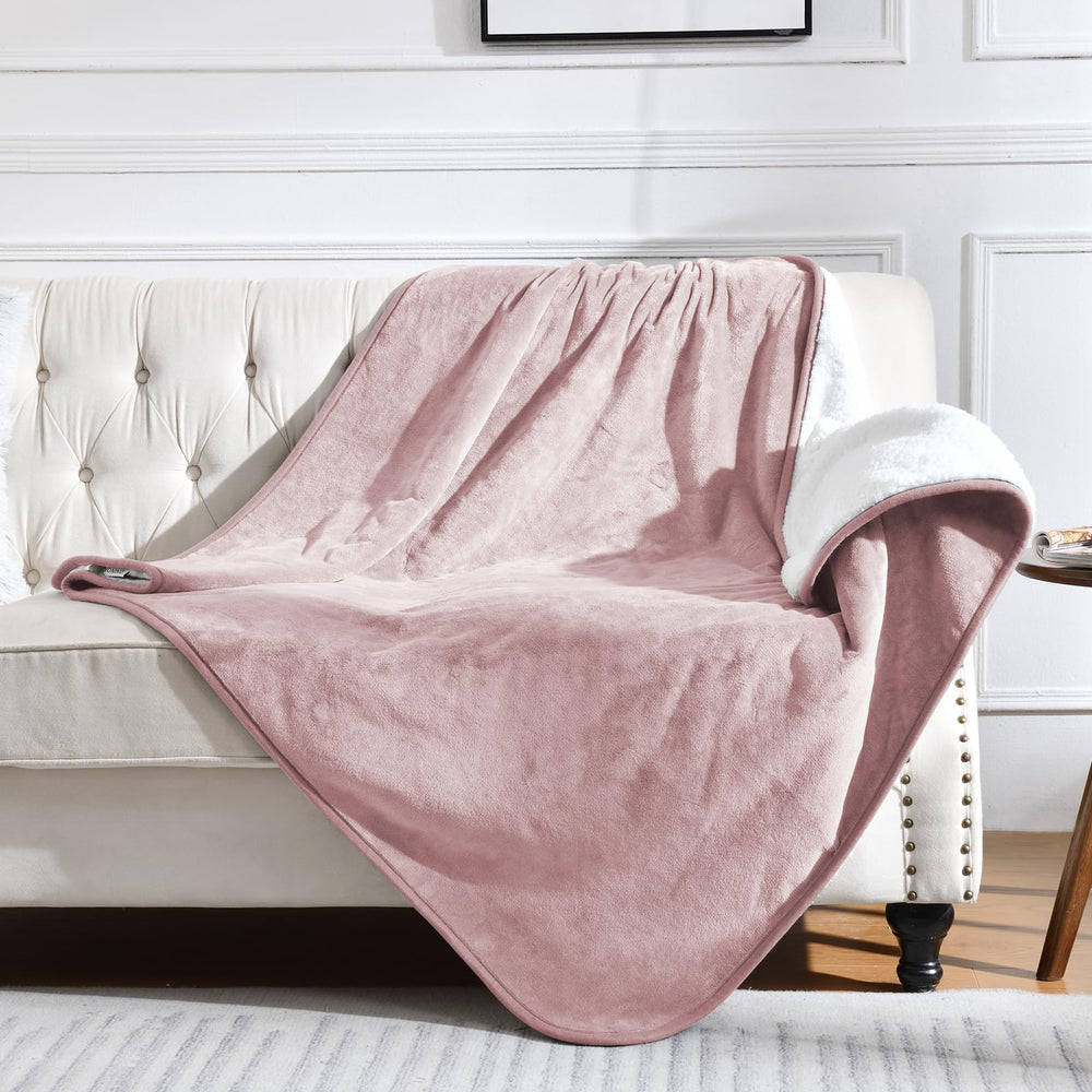 Yaning waterproof blanket bed top view in dusty pink provides cozy bed protection