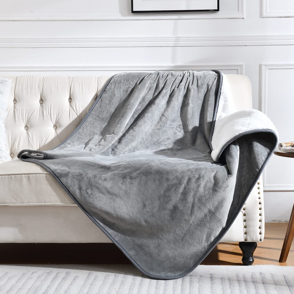 Yaning waterproof blanket on a grey sofa protects from spills and pet fur