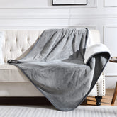 Yaning waterproof blanket on a grey sofa protects from spills and pet fur