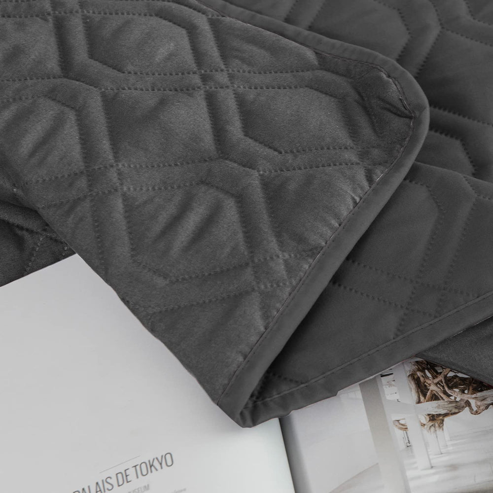 Ameritex reversible bed cover shown on chair blending with decor while guarding against accidents