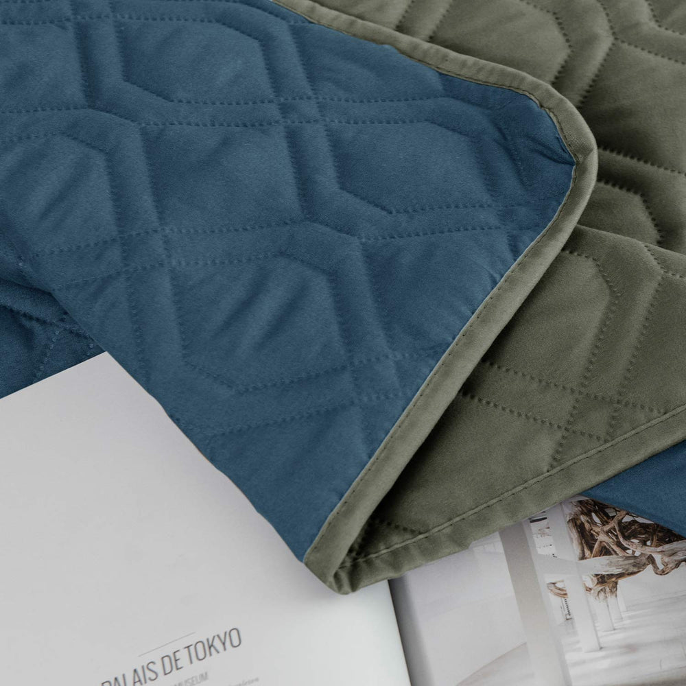 Ameritex waterproof furniture cover protecting bed and couch surfaces.