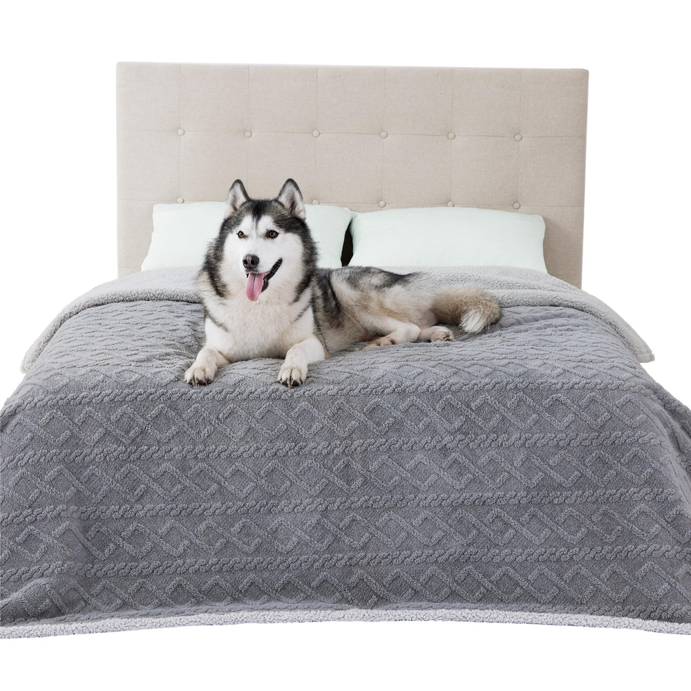 Bedsure waterproof dog blanket on bed protects furniture from spills and pet hair.