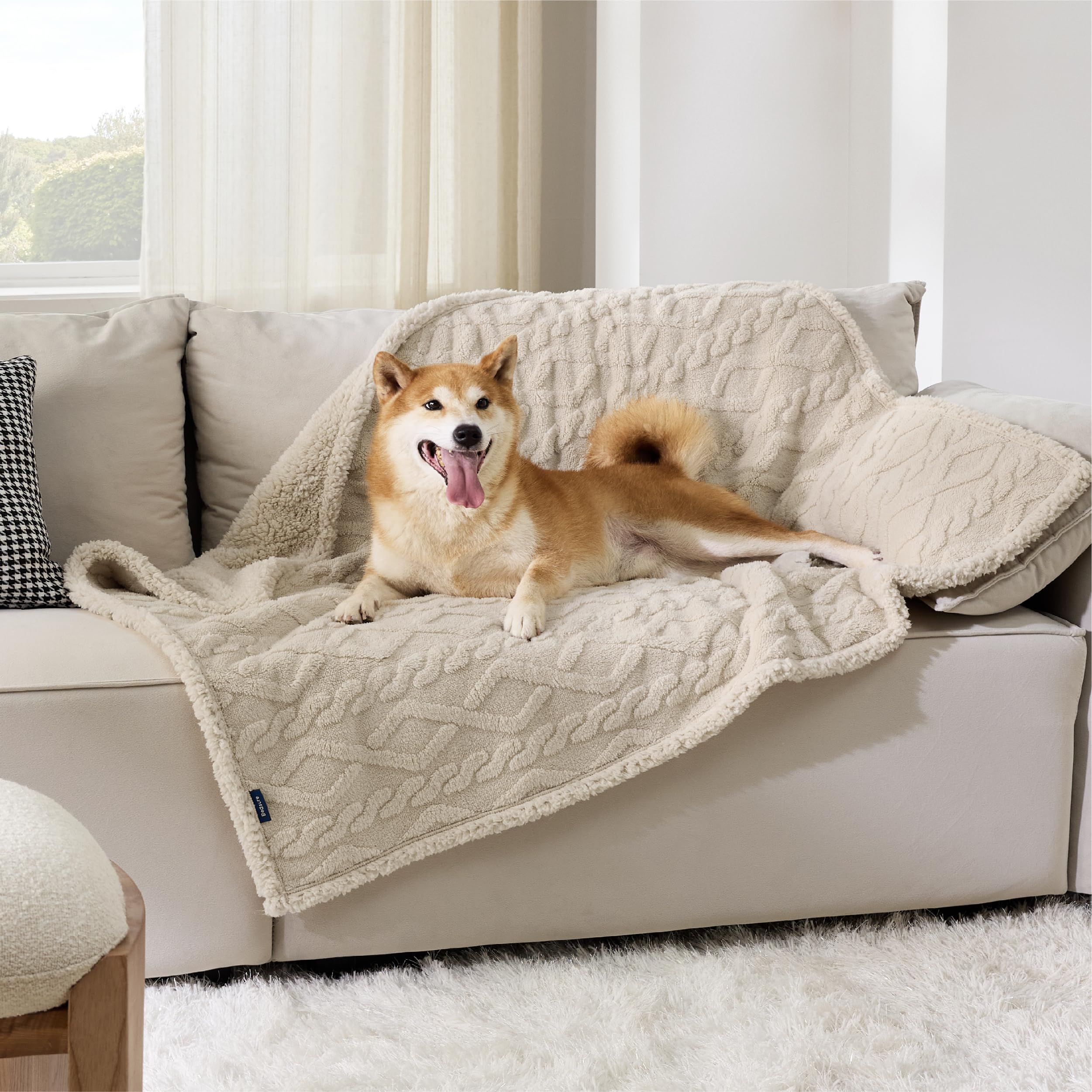 Bedsure waterproof dog blanket on couch protector guards furniture against spills.
