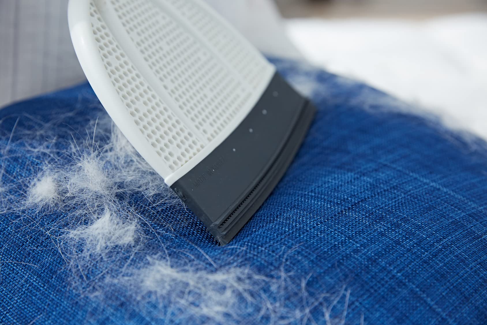 Broombi Pet Hair Remover cleans car seats for travel-ready interiors.