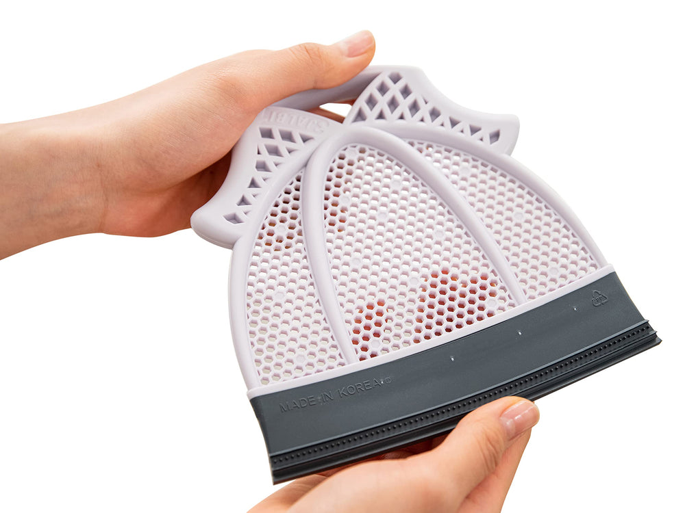Broombi Pet Hair Remover quad-blade close-up removes fabric hair.
