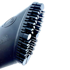 Buff Brite Fur Remover Pro II in action grooming a dog on a couch.
