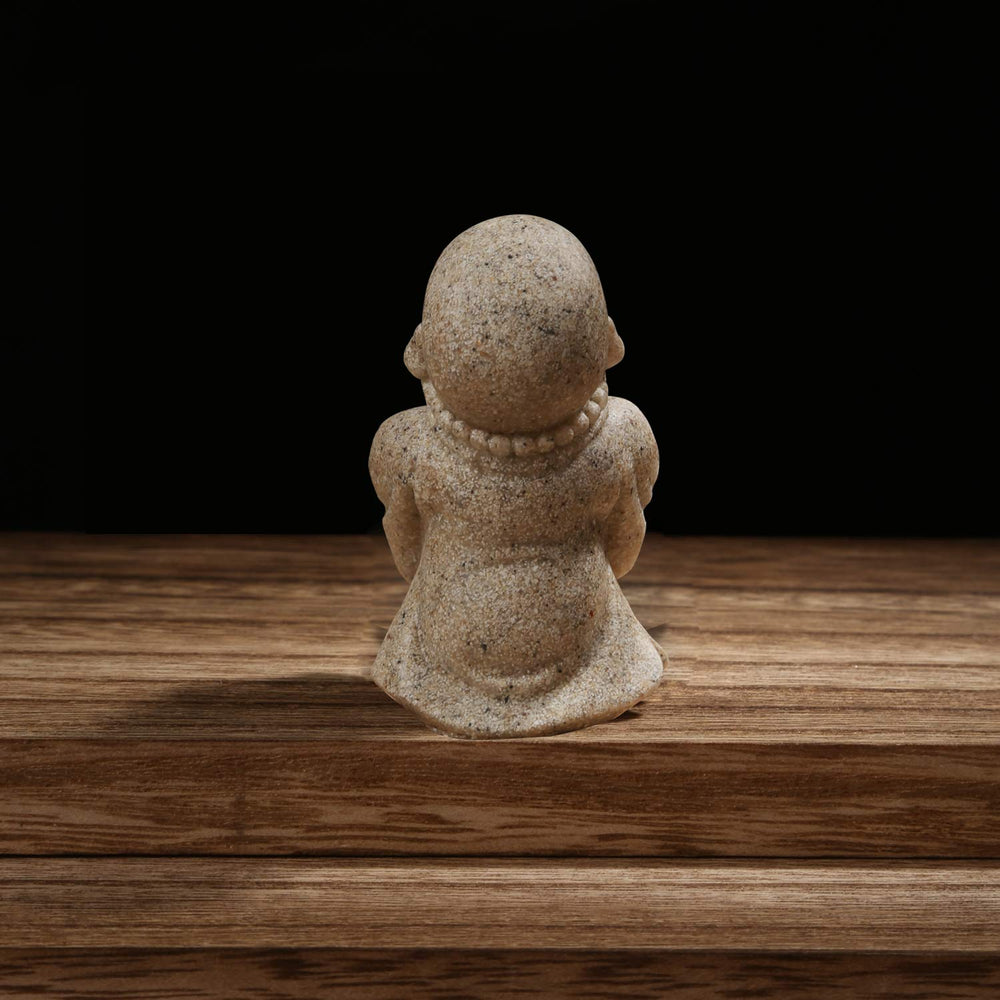 Carefree Fish Buddha statue handcrafted-sandstone texture enhances meditation corner with earthy vibe.