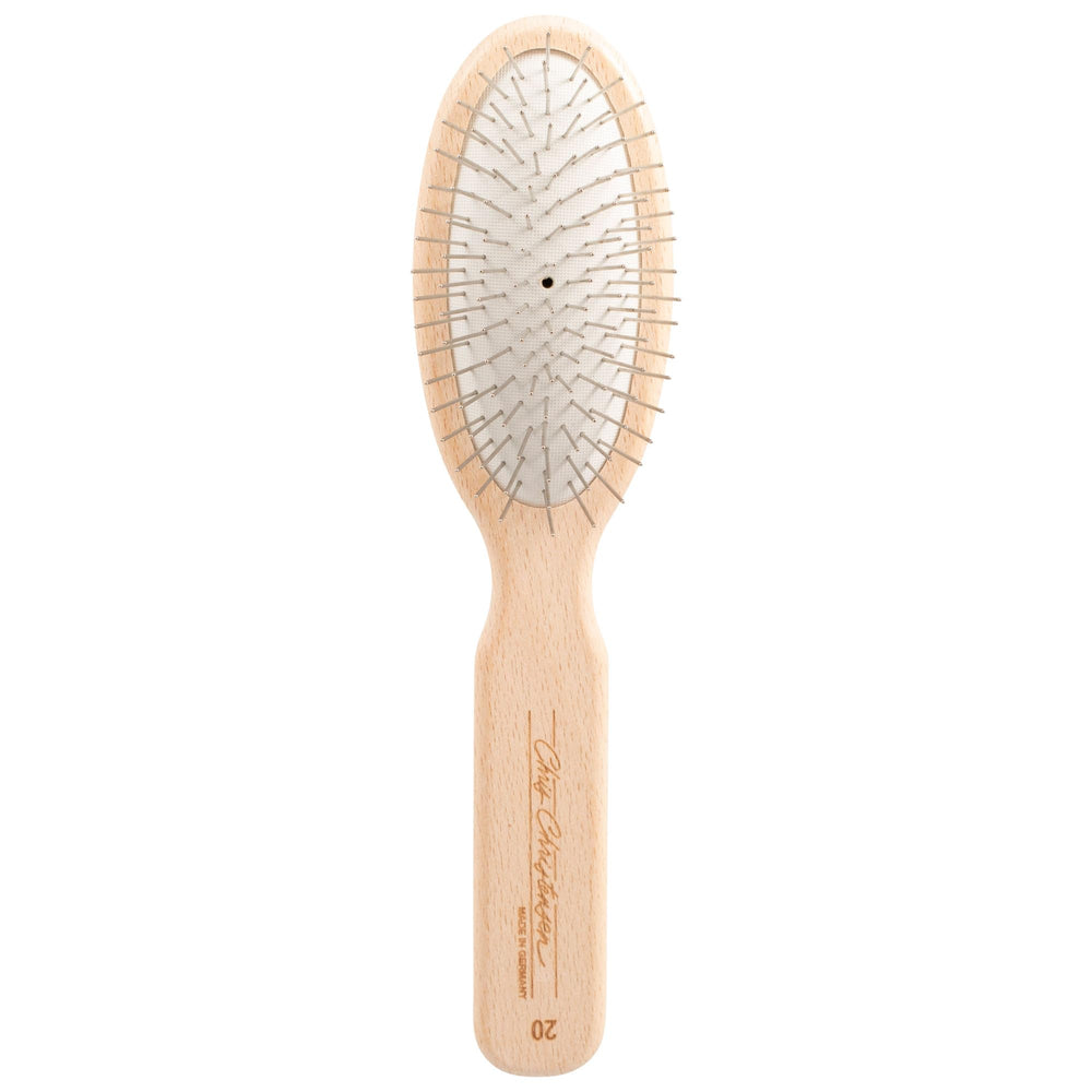 Chris Christensen 20mm oval-pin dog brush gliding through delicate coat for gentle grooming