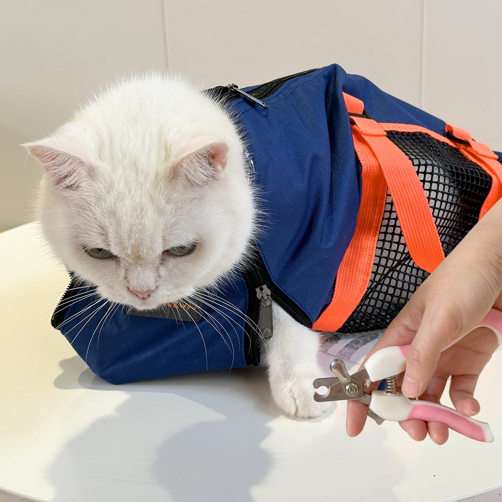 Cinf grooming bag with muzzle in navy blue helps calm ferocious cats during grooming sessions.