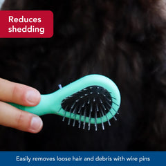 Coastal Li'l Pals Dog Combo Brush in a grooming session setup for easy handling.