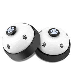 Comsmart dog training bell set on the floor with non-slip base for steady training cues.