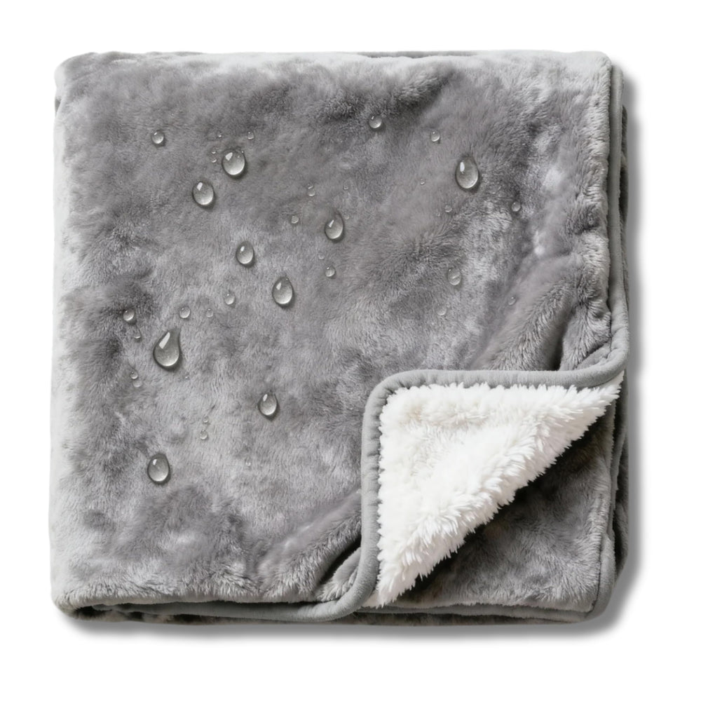 CREW FLX Waterproof Blanket on gray bed protects against spills and stains.