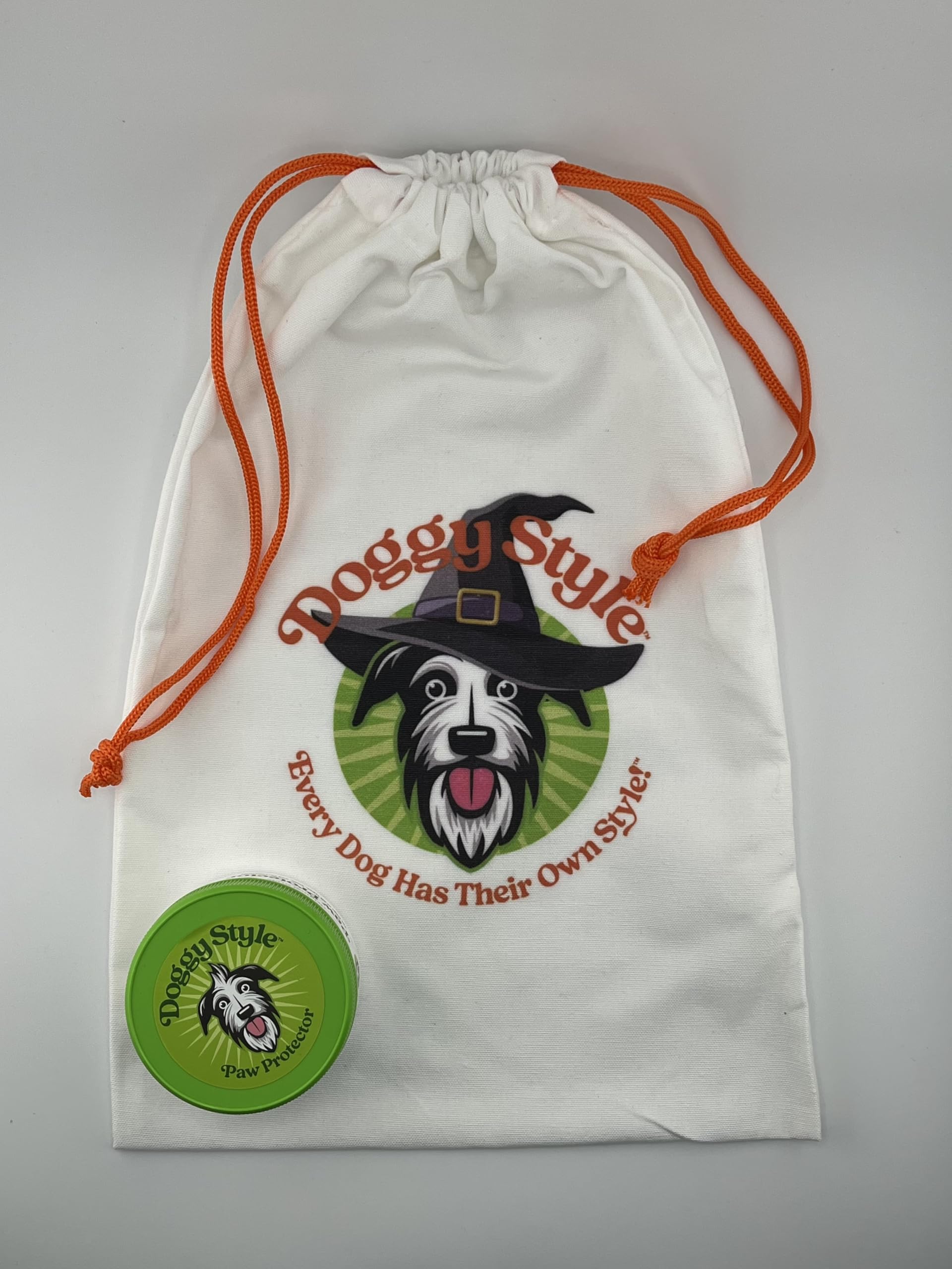 Doggy Style paw balm being applied to a dog's paw with natural ingredients