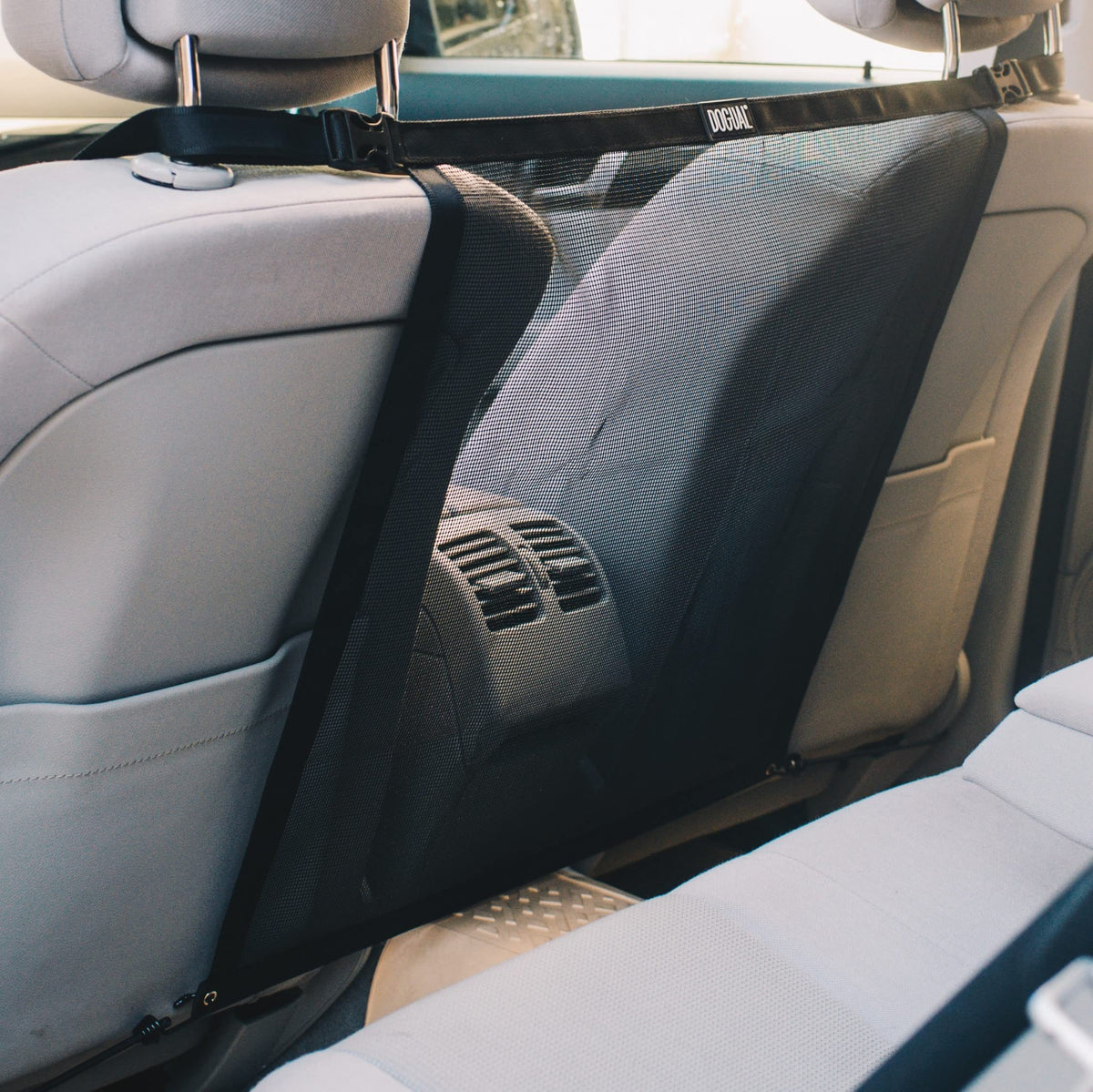DOGUAL dog car barrier universal-fit mesh keeps pets safely in backseat during drives.