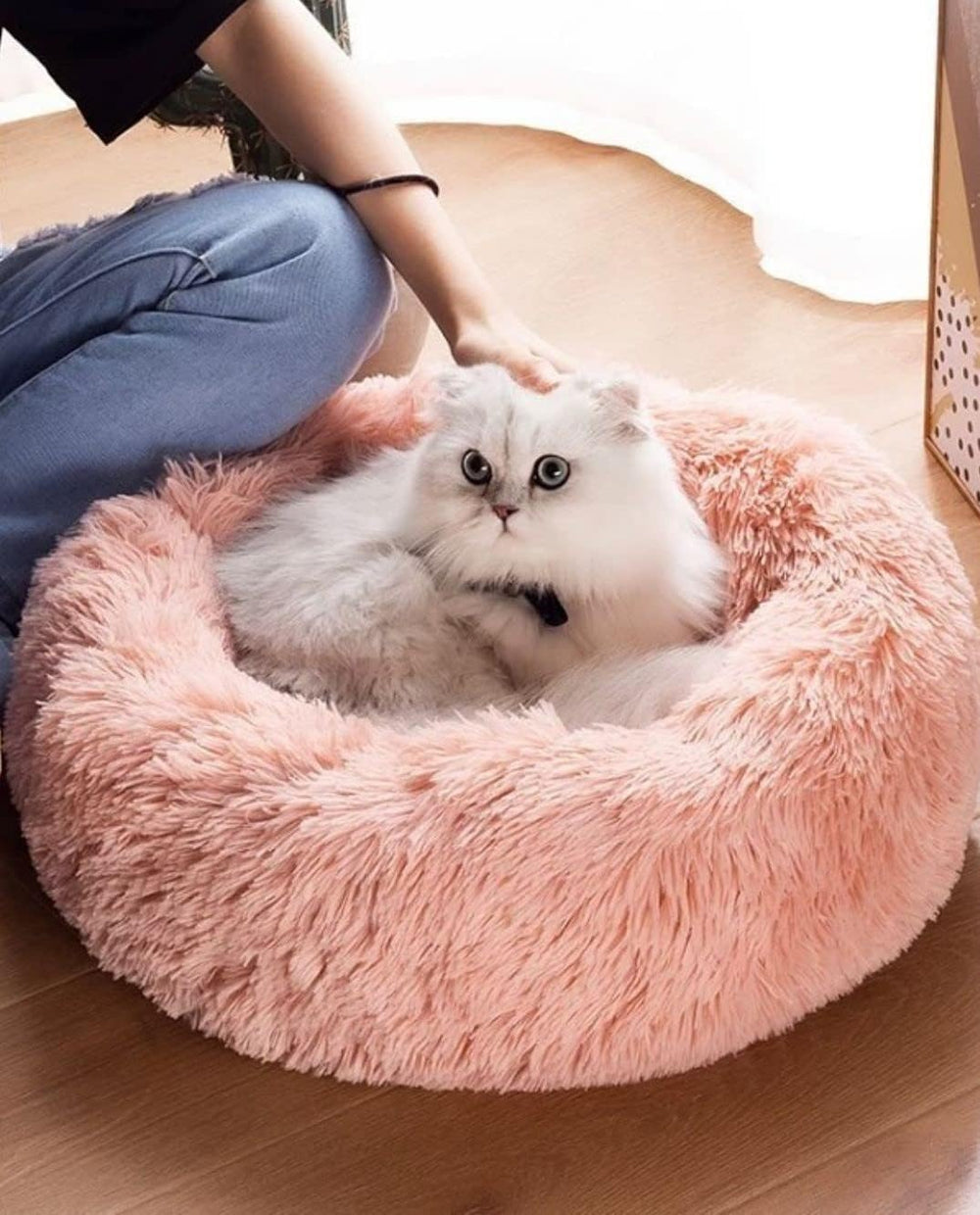 Donut pet bed pink round with moisture-proof bottom protection.