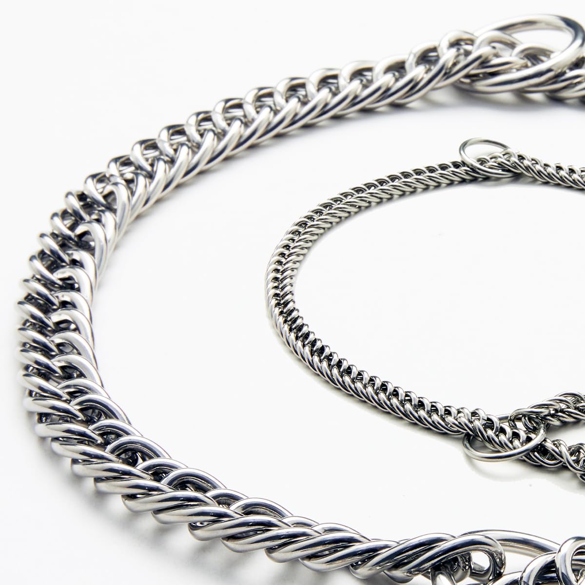 Double-Twist Link Training Choker Collar on leash during urban walk demonstrates steady guidance.