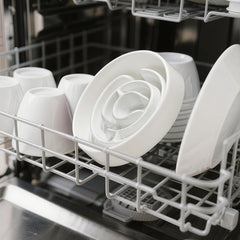 Facdiary ceramic white slow-feeder bowl demonstrated as dishwasher-safe for easy cleanup.