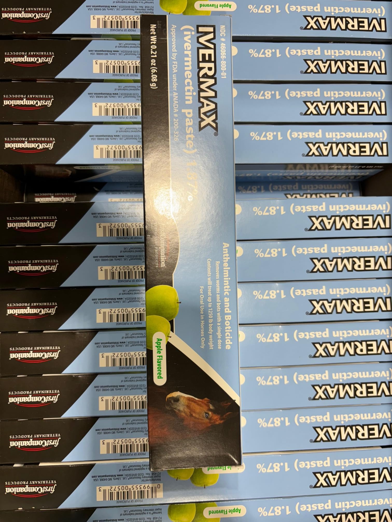 First Companion Ivermax blue packaging with horse care supplies in view.
