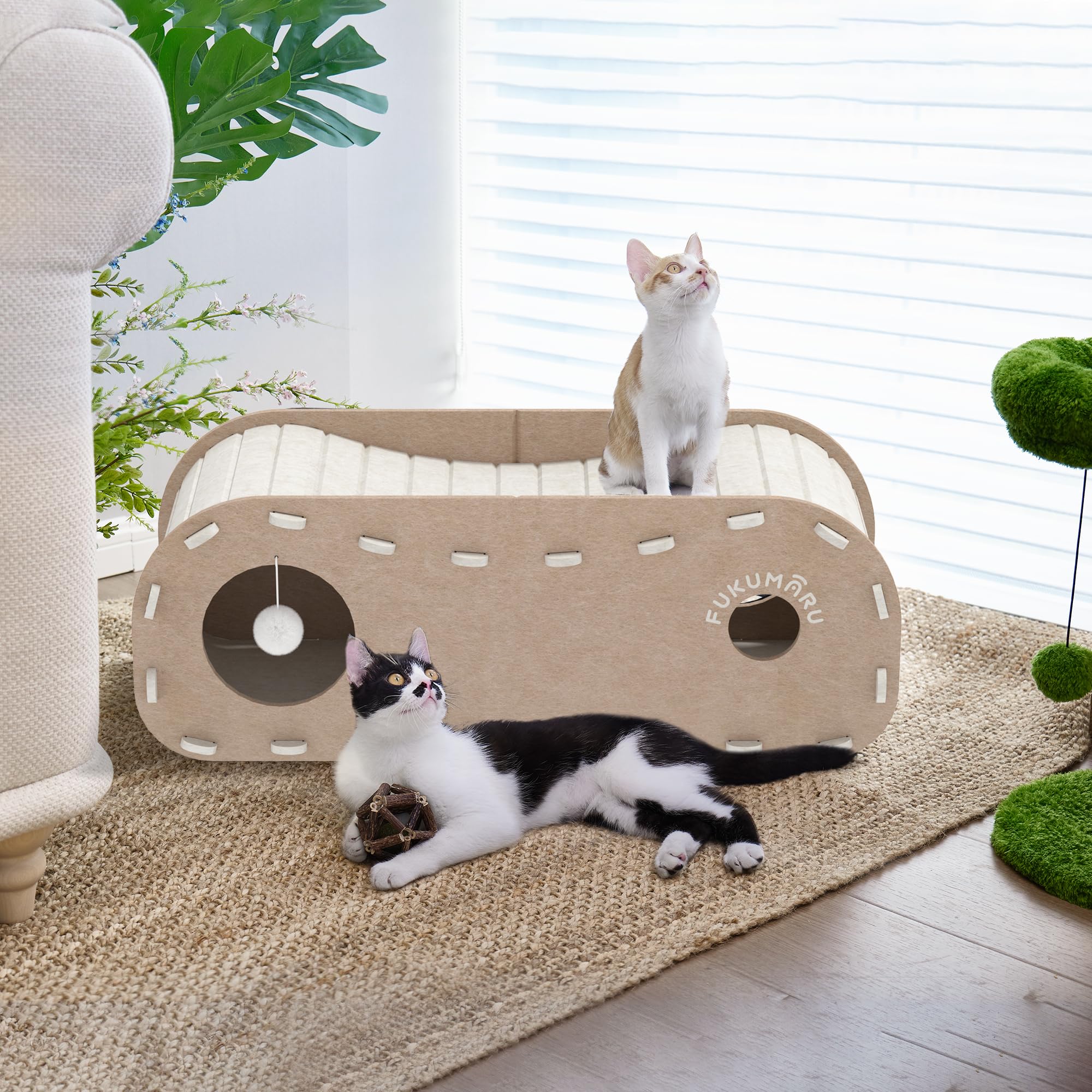FUKUMARU cat bed large outer entrance and small holes for interactive play.