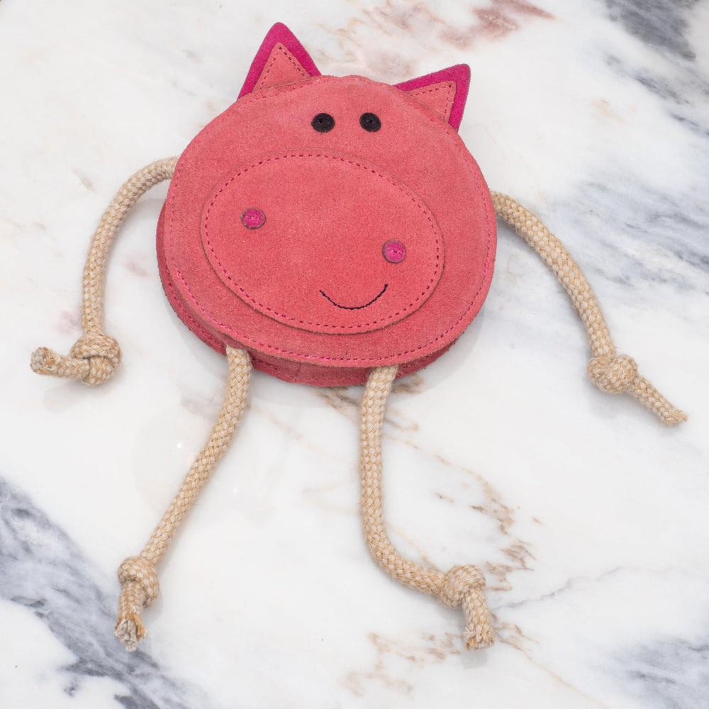 Fuzzl Eco Leather Pickles Pig dog chewing a plush mushroom.